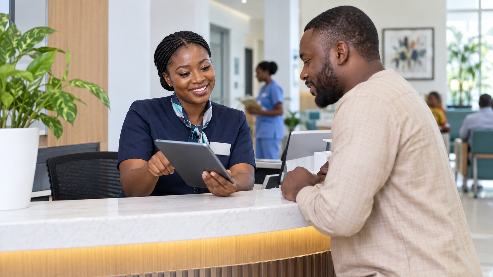 Hospital staff member helping a visitor book an appointment